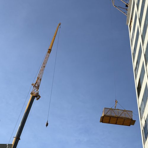 Material Basket attached to a DOC® Material Hoist above allows materials to be delivered through windows and other smaller openings in existing construction. Great for remodel projects.