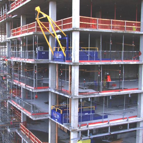 The tower crane keeps working while DOC handles the concrete forms, reshoring, and other materials.